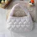 Close-up of pink quilted handbag with heart patterns on soft fabric background - Quilted Big Heart Light Pink