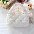 Detailed close-up of quilted white handbag with pink bow embroidery and soft fabric texture - Pink Embroidered Bow