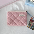 Close-up of pink quilted coin purse with diamond pattern and light blue lanyard handle - Quilted Pleated Pink