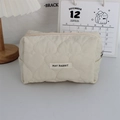 Detailed view of quilted heart pattern and zip closure on the cream makeup bag - Quilted Large Heart Beige White