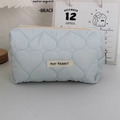 Detailed view of light blue quilted heart cosmetic bag with metal zipper and logo patch - Quilted Large Heart Light Blue