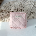 Close-up of pink quilted mini cosmetic pouch with May Rabbit label and zipper detail - Quilted Pleated Light Pink