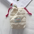 Close-up of quilted cream camera pouch featuring pink drawstrings and heart patterns - Quilted Large Heart Beige White