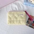 Detailed view of yellow quilted makeup bag with heart pattern and pink zipper pull - Quilted Large Heart Yellow