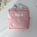 Detailed view of pink quilted cosmetic bag with zipper and May Rabbit brand label - Quilted Pleated Pink