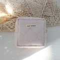 Detailed view of pink heart quilted fabric with May Rabbit label on small makeup bag - Quilted Large Heart Light Pink