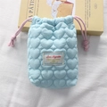 Macro shot of light blue heart-quilted camera pouch with pink drawstrings and soft texture - Quilted Small Heart Blue