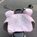 Detail of pink waterproof handlebar muffs with thick plush lining and cartoon dog print - Pink Dog