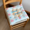 Detail of quilted chair pad featuring a cute puppy print on a rustic wooden chair - 40x40cm / Yellow Check