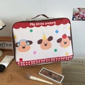 Detail view of cartoon dog print storage bag with cosmetics and makeup accessories - Three Puppies