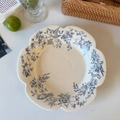 Close-up of French vintage ceramic plate with wavy edges and blue floral bird pattern - 9-inch Petal Plate