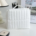 Vertical quilted white cosmetic storage bag with sturdy top handle for travel - Off White