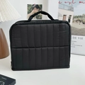 Vertical quilted black toiletry bag with soft top handle and secure zipper closure - Black