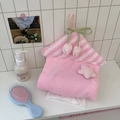 Detail of pink house-shaped tissue bag with tulip charms and soft coral fleece texture - Pink Star + Pink Tulip