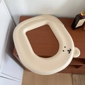Detail of waterproof beige bear toilet seat cover with cute ears on wooden surface - Off White