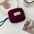 Flat lay of red and blue quilted checkered storage bag with yellow zipper and accessories - Red and Blue Plaid