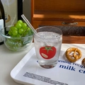 Close-up of tomato pattern glass cup with straw in a warm, sunny lifestyle setting - 260ml / Tomato