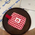 Detailed macro view of the soft red plaid plush fabric and Hello Kitty apple logo patch - Tofu Bag (Red Plaid)