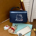 Close-up of the cat embroidery and Jolly House text on blue denim makeup bag - Cowboy Cat