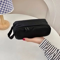 Detail of a large black double-zipper stationery bag with a durable side handle strap - Black