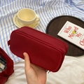 Macro detail of wine red nylon pencil case showing double zippers and large storage layers - Burgundy