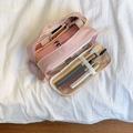 Pink multi-compartment travel toiletry bag showing internal mesh pockets for brushes - Pink
