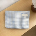 Close-up of blue gingham pouch with bow embroidery and brand woven label on desk - Grey Striped (03) / Large