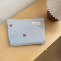 Detailed shot of blue striped makeup bag with red bow embroidery on a wooden surface - Pink Striped (02) / Large