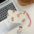 Close-up of a quilted coin purse with teddy bear patterns on a laptop keyboard - Pink Bear