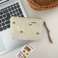 Detailed close-up of quilted ivory pouch with brown bow embroidery and rope handle - Milk Tea Bowknot