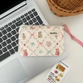 Close-up of quilted cream pouch featuring cute cartoon bear and bunny patterns - Dessert Sheep