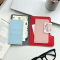 Detail of color-block leather passport holder with multi-card slots and travel storage - Red Blue Patchwork