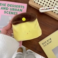 Detailed close-up of a plush caramel pudding coin purse held in hand with soft textures - Caramel Pudding
