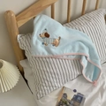 Detail of light blue towel with cute dog embroidery and pink wavy scalloped edges - Hair Drying Cap
