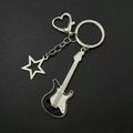 Detailed close-up of Y2K black electric guitar and star charms on a metal keychain - Black Guitar Keychain [Style 1]