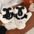 Funny white plush mittens with cartoon coal ball design on a warm wooden tabletop - Soot Sprite Style / White