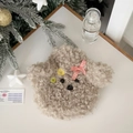 Detail of cute teddy dog plush hot water bottle with festive checkered bow on white desk - Beige
