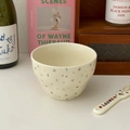 Detail of cream ceramic star bowl with a matching Happy strawberry ceramic spoon - Colorful Water Drop Stars