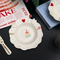 Detailed view of white ceramic dessert plate with 3D embossed animals and flower edges - Rabbit & Cat