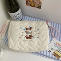 Detail of white quilted cosmetic bag featuring cute embroidered puppies and pink lanyard - White (With Lanyard)