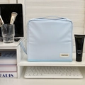 Light blue portable makeup bag with handle and partitioned storage for travel cosmetics - Blue