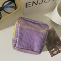 Detail view of purple mesh makeup bag with contrast yellow zipper and breathable mesh texture - Purple