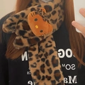 Detail of plush leopard print scarf featuring a cute cartoon kitty plush ornament - Dark Leopard Print Scarf
