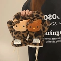 Detail of plush leopard print mittens featuring cute cartoon characters and white lanyards - Dark Leopard Print Gloves