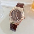 Detail of rose gold case with crystal bezel and brown star dial on leather strap watch - Brown