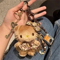Brown plush cat charm in leopard print dress with golden heart and camera accessories - Maillard Style Cat