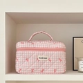 Pink and white checkered quilted makeup bag featuring a bow and top handle on a shelf - Large / Plaid Pink Bow