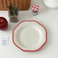 Detailed relief pattern on vintage ceramic plate with red scalloped edges and white dots - Red