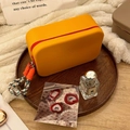 Silicone cosmetic bag with orange matte finish, red zipper and braided handle strap - Orange Sweet Red With Lanyard