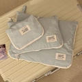 Waterproof light blue travel organizer bags with white zippers on a beige suitcase - Small / Gray Blue